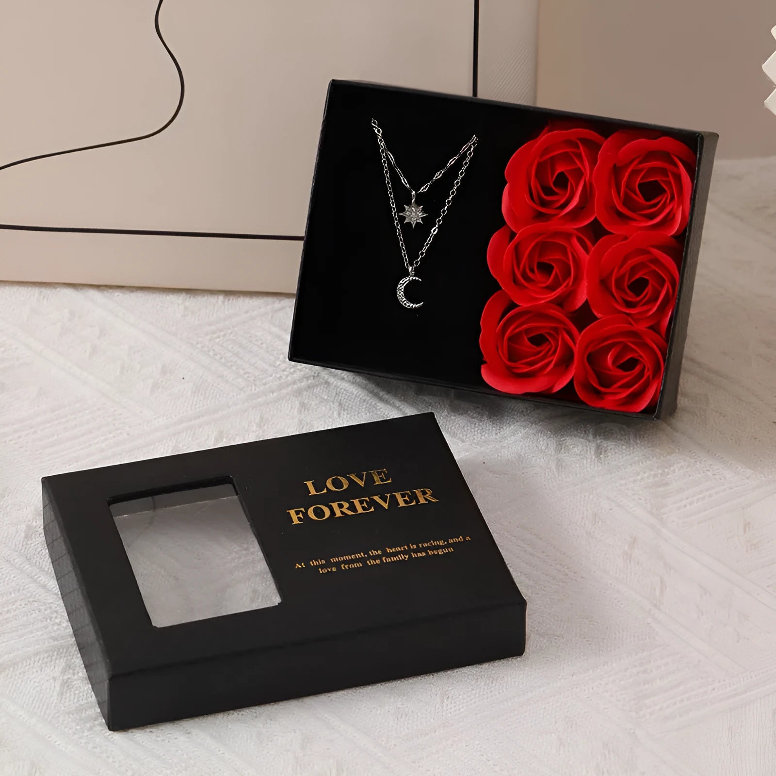 Red Valentine's gift box open to show six pink soap roses with a matching handbag beside it