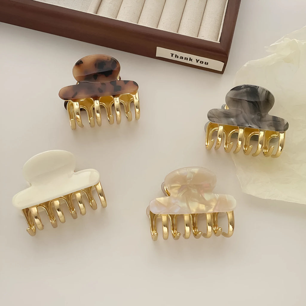 Women's retro acetate hair barrette with metal alloy grip in creamy-white, fairy white, ink colour, and leopard print variations