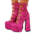 Black women's platform high heels with a thick heel, serpentine ankle strap, and round toe.