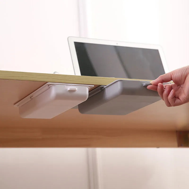 Plastic adhesive under-desk storage drawer with cover, shown in various colours and sizes.