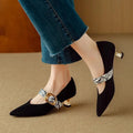 Women's black French point high heels with buckle fastening and stiletto heel