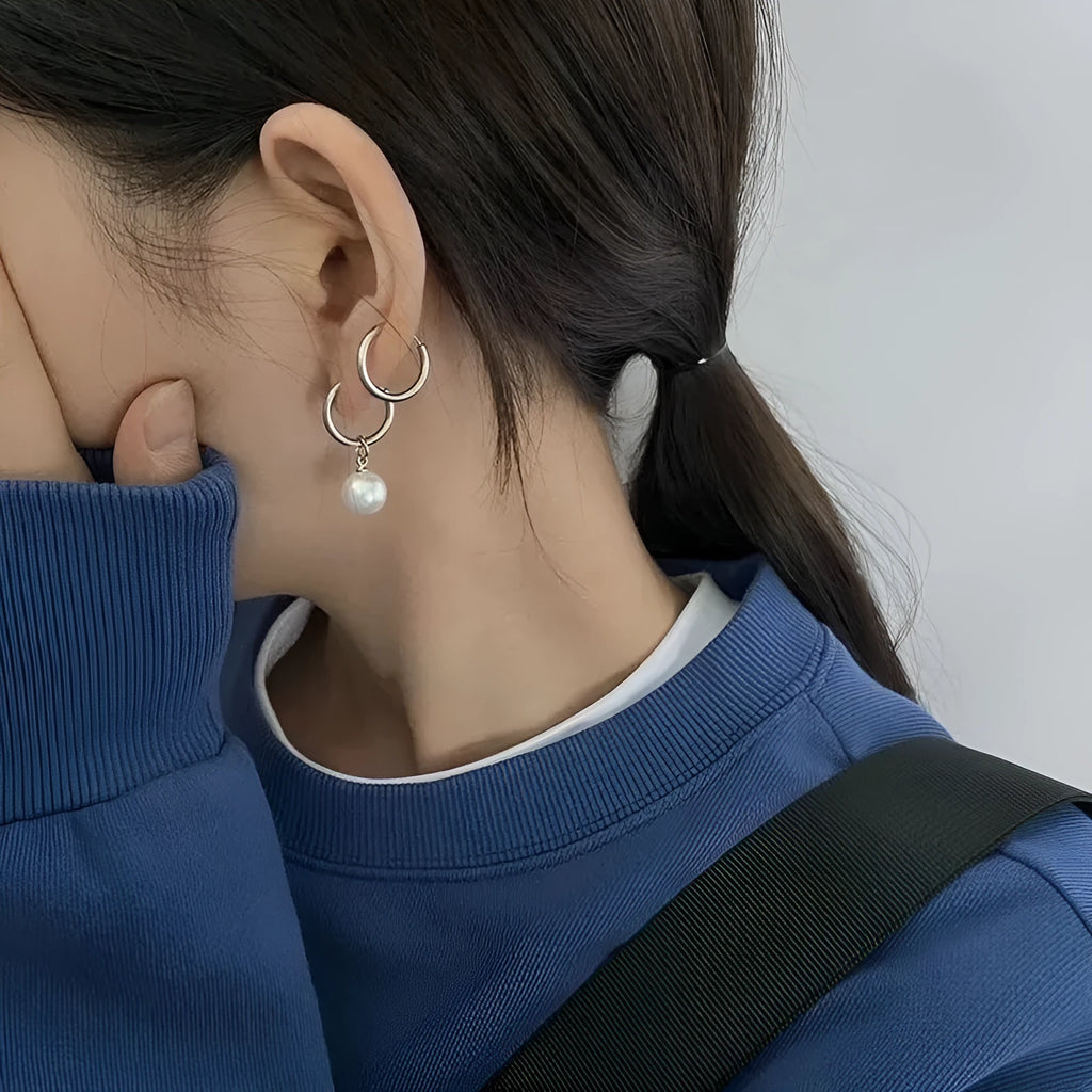 Geometric pearl earrings with titanium steel components and round pearl detailing