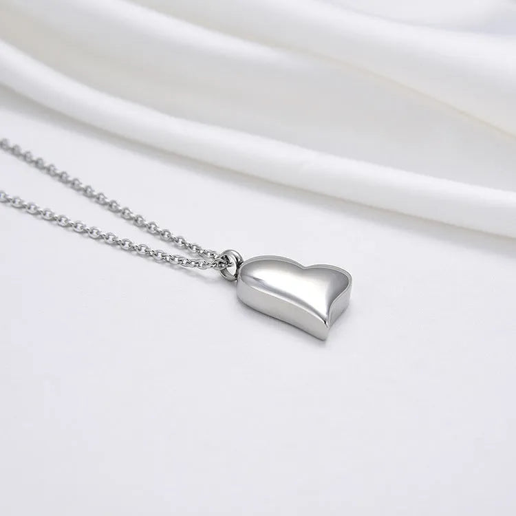 Silver curved peach heart stainless steel pendant necklace on adjustable length chain