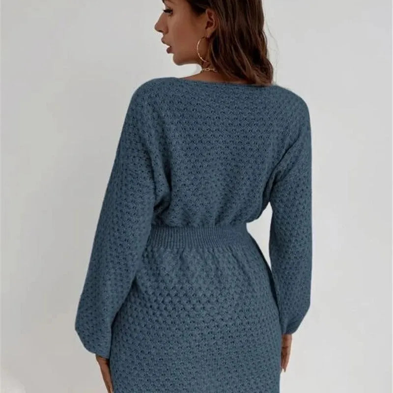 Blue women's knitted dress with crocheted flowers, a round neck, fitted waist, and long sleeves.