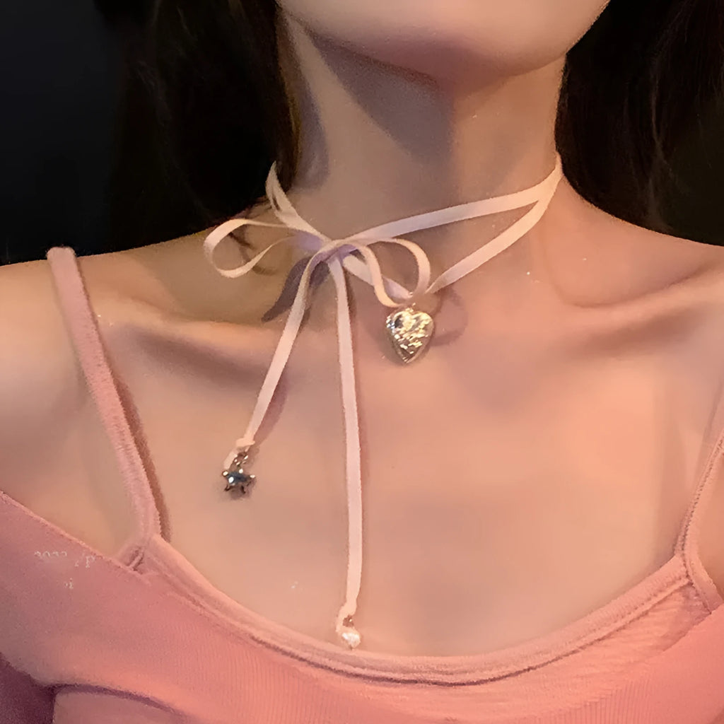 Women's ribbon love pendant necklace on a clavicle chain in an electroplated alloy, shown in one of 33 colour options.