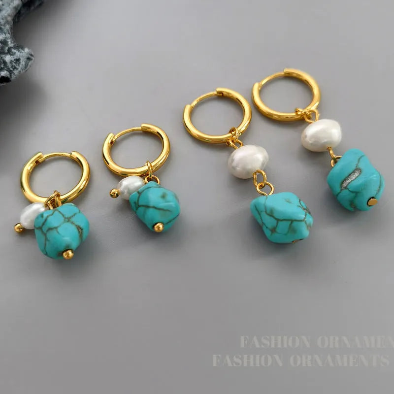 A pair of geometric clip-on earrings made of copper with turquoise and cultured pearls.