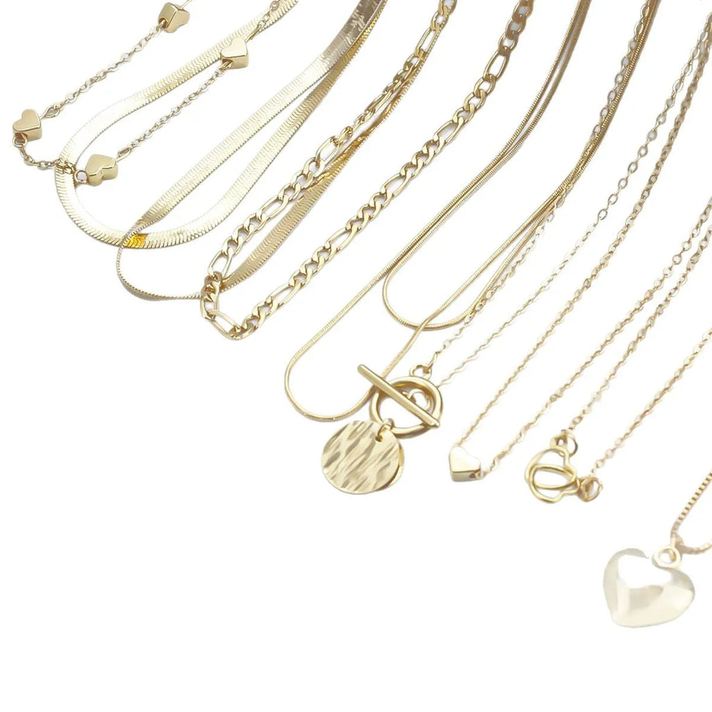 Set of ten gold women's fashion necklaces with snake bone chains and adjustable length on a white background.