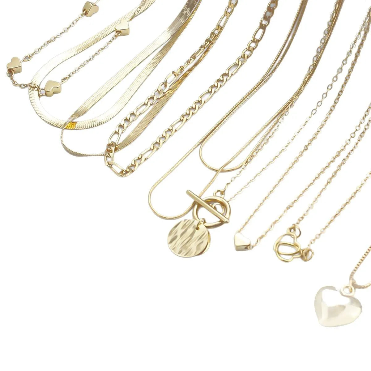 Set of ten gold women's fashion necklaces with snake bone chains and adjustable length on a white background.
