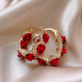 Red flower-shaped alloy ear clip earrings with rose design elements for women