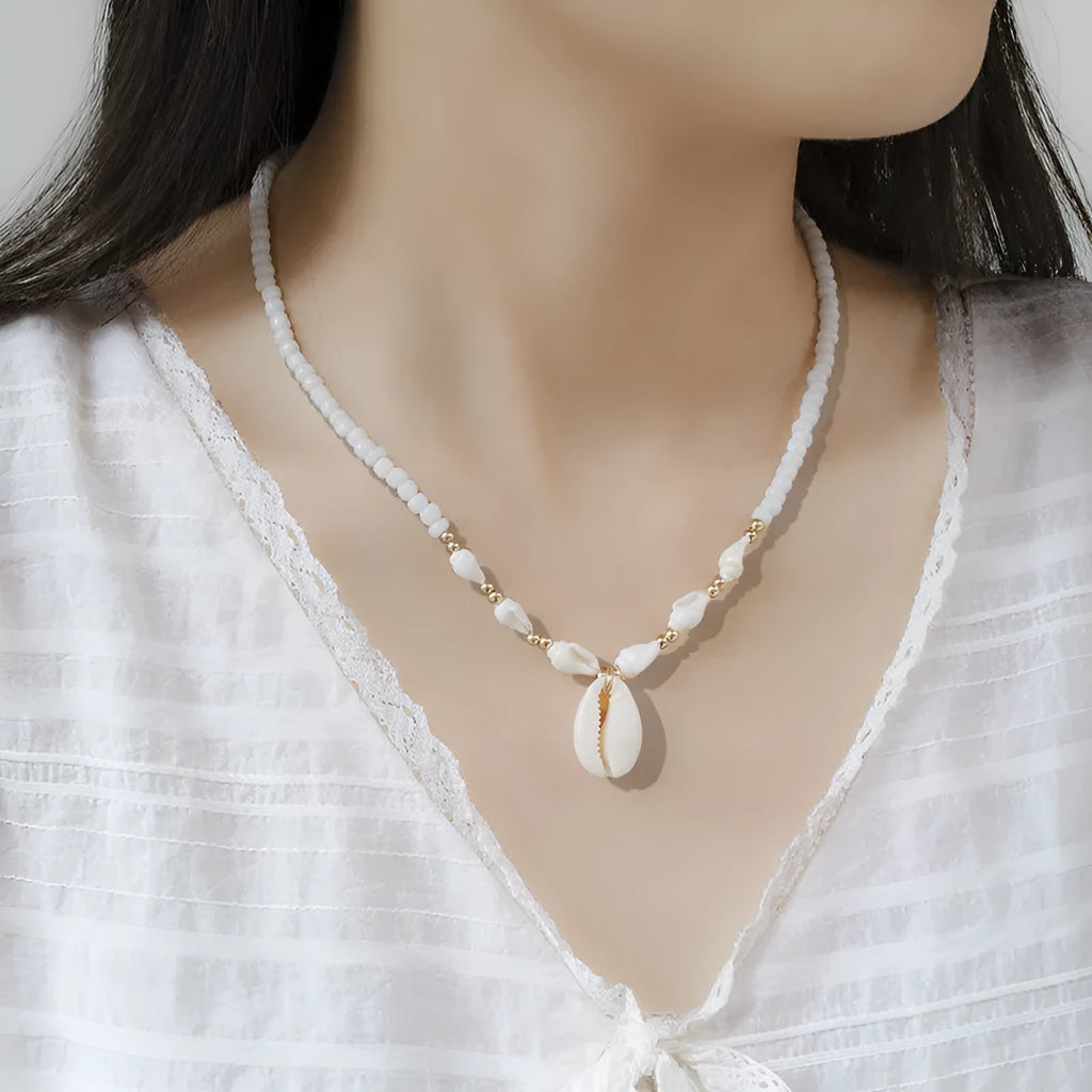 White conch shell bead necklace with a mother of pearl pendant on a regular chain.