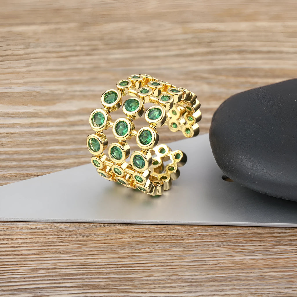 Copper ring with 18K gold plating and green zircon stones in exaggerated wide-band design
