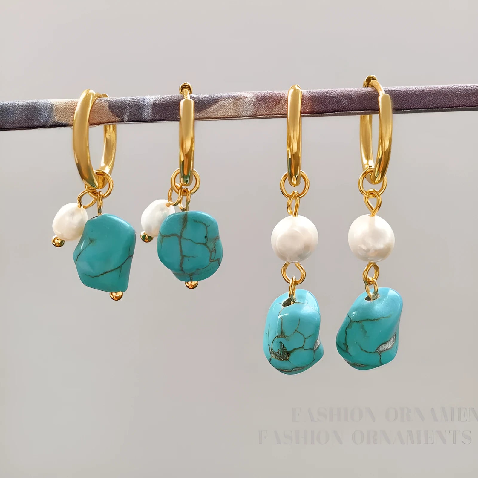 A pair of geometric clip-on earrings made of copper with turquoise and cultured pearls.