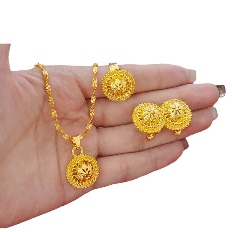 Gold-plated three-piece jewellery set with Middle Eastern flower design, showing necklace, pendant earrings, and ring.