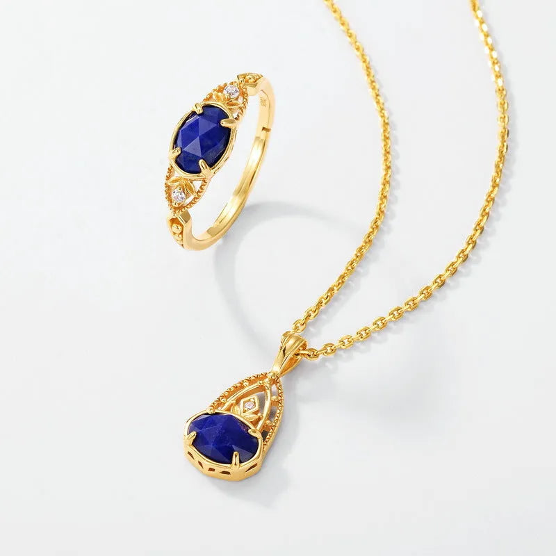 A silver geometric ring with a natural blue lapis lazuli stone, showing ellipse shape and round details.