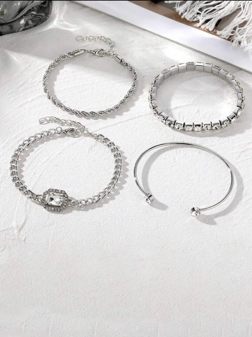 Set of four women's alloy bracelets with geometric square diamond charms and metal chains in gold or silver.