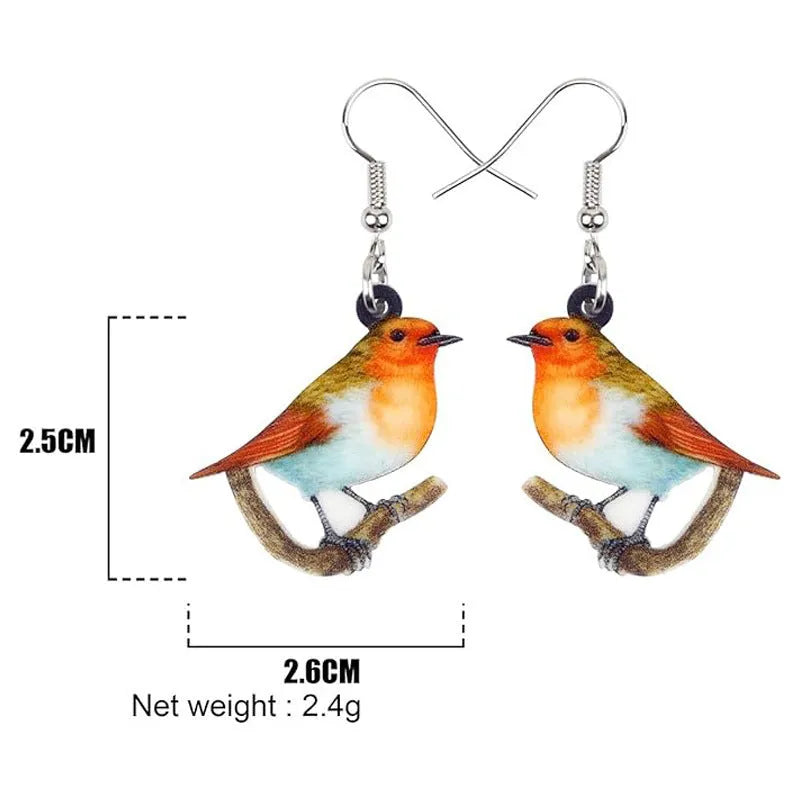Pair of blue and white acrylic pendant earrings featuring a printed titmouse bird and snake design on geometric shapes.