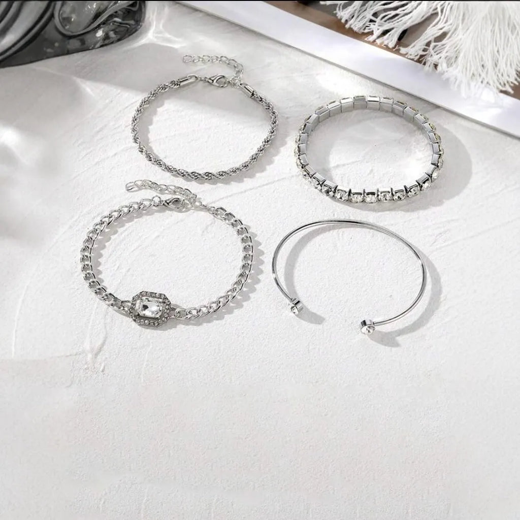 Set of four women's alloy bracelets with geometric square diamond charms and metal chains in gold or silver.