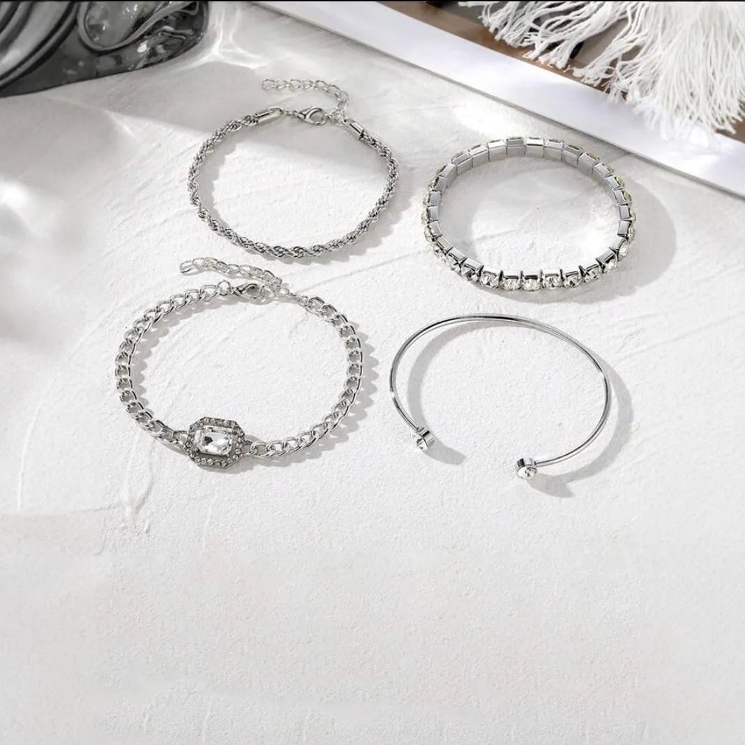 Set of four women's alloy bracelets with geometric square diamond charms and metal chains in gold or silver.