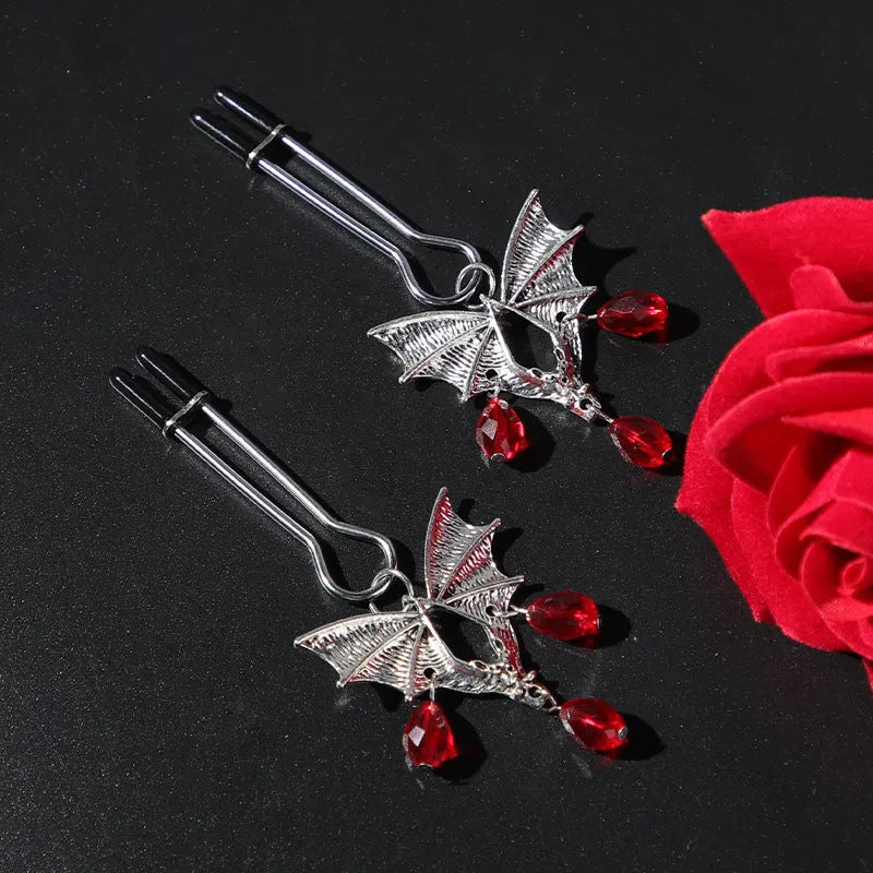 Silver alloy bat nipple clamp with adjustable tension and ruby detailing