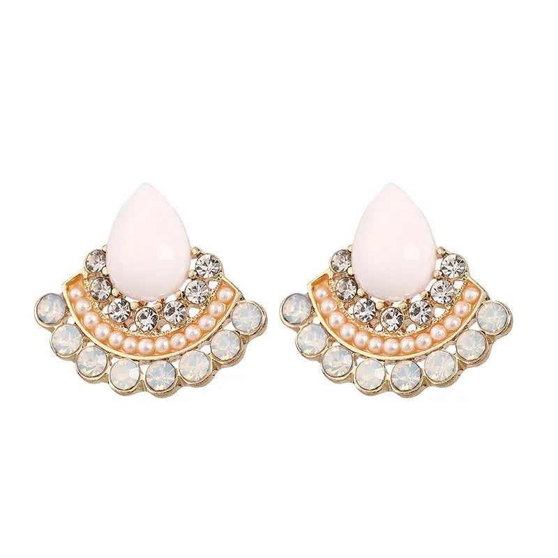 Women's retro-style silver fan-shaped earrings with rhinestone and opal decoration on a white background.