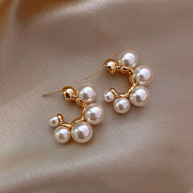 A pair of red bell-shaped drop earrings for women, made from metal alloy.