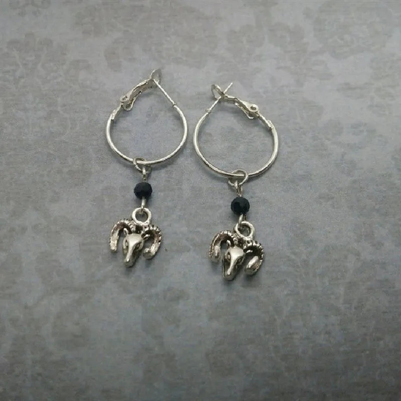 Silver-coloured alloy round hoop earrings for women with a Tibetan antelope design detail.