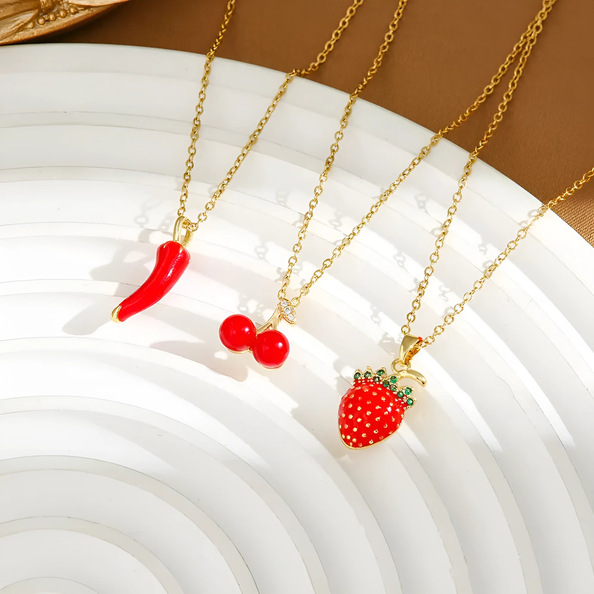 Delicate red indie cherry and strawberry pendant on a titanium steel O-ring necklace chain.
