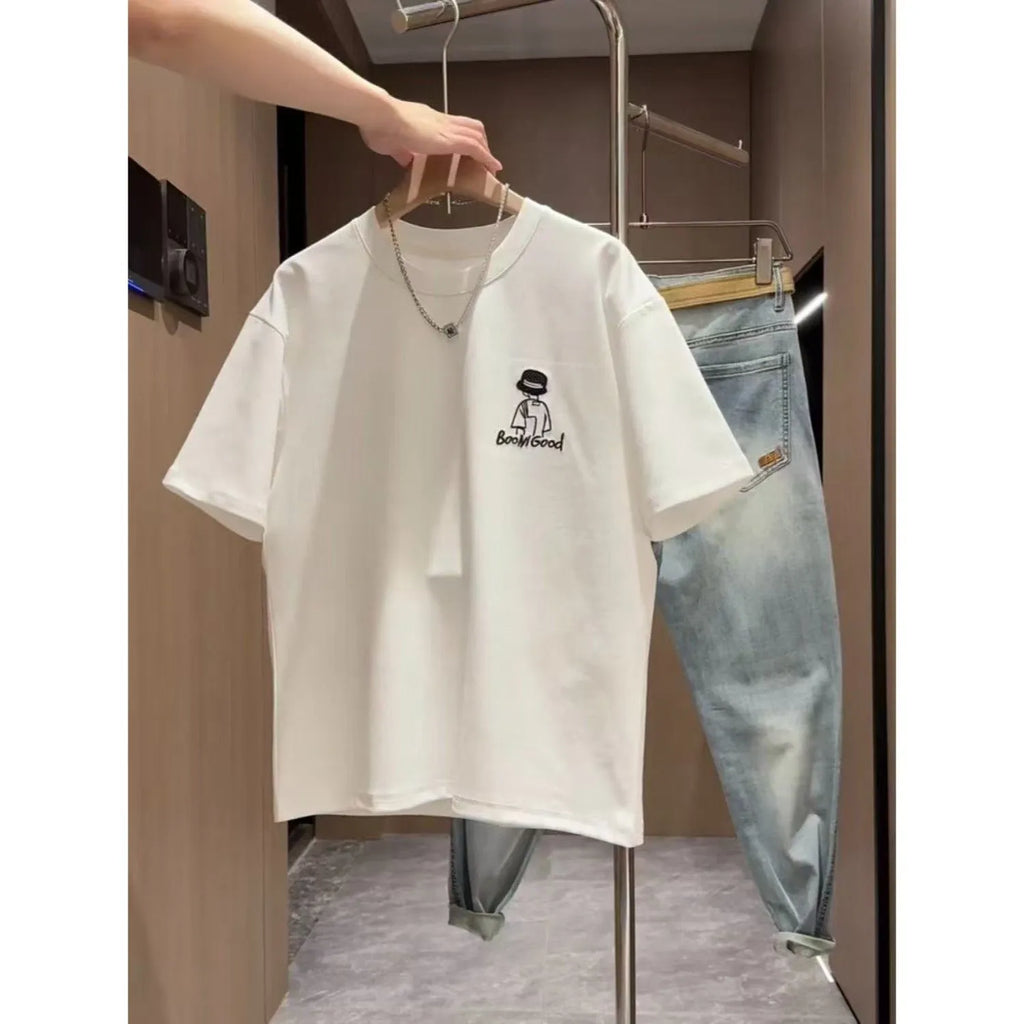 Man wearing a black slim fit pure cotton t-shirt with a simple cartoon print design on the front.