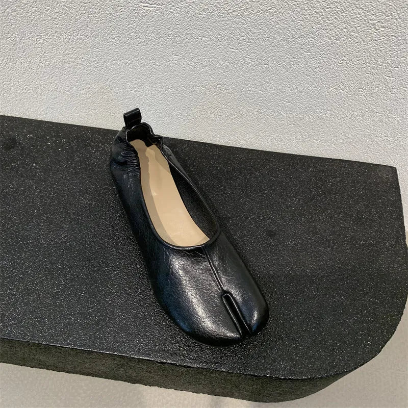Women's black split toe horseshoe design pumps with a chunky low heel and round toe.