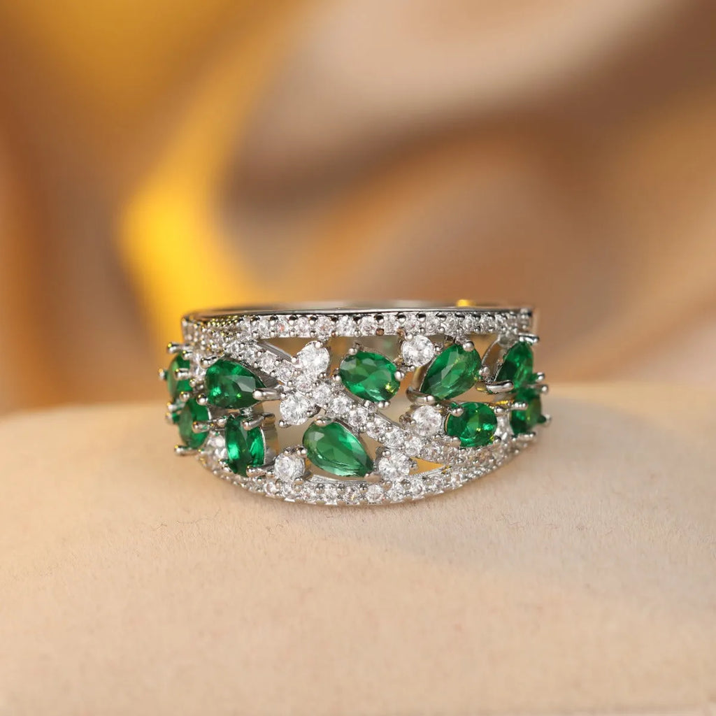 Women's round hollow copper fashion ring with a gemstone centrepiece, shown in gold and platinum colour options.