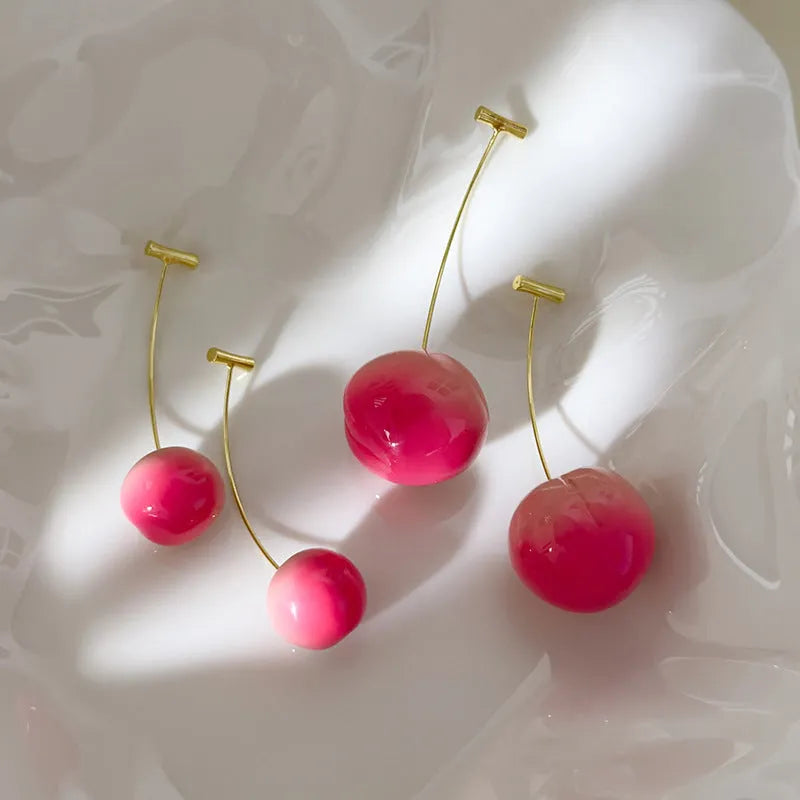 A pair of acrylic earrings shaped like detailed peaches on copper posts, shown in small and large size options.