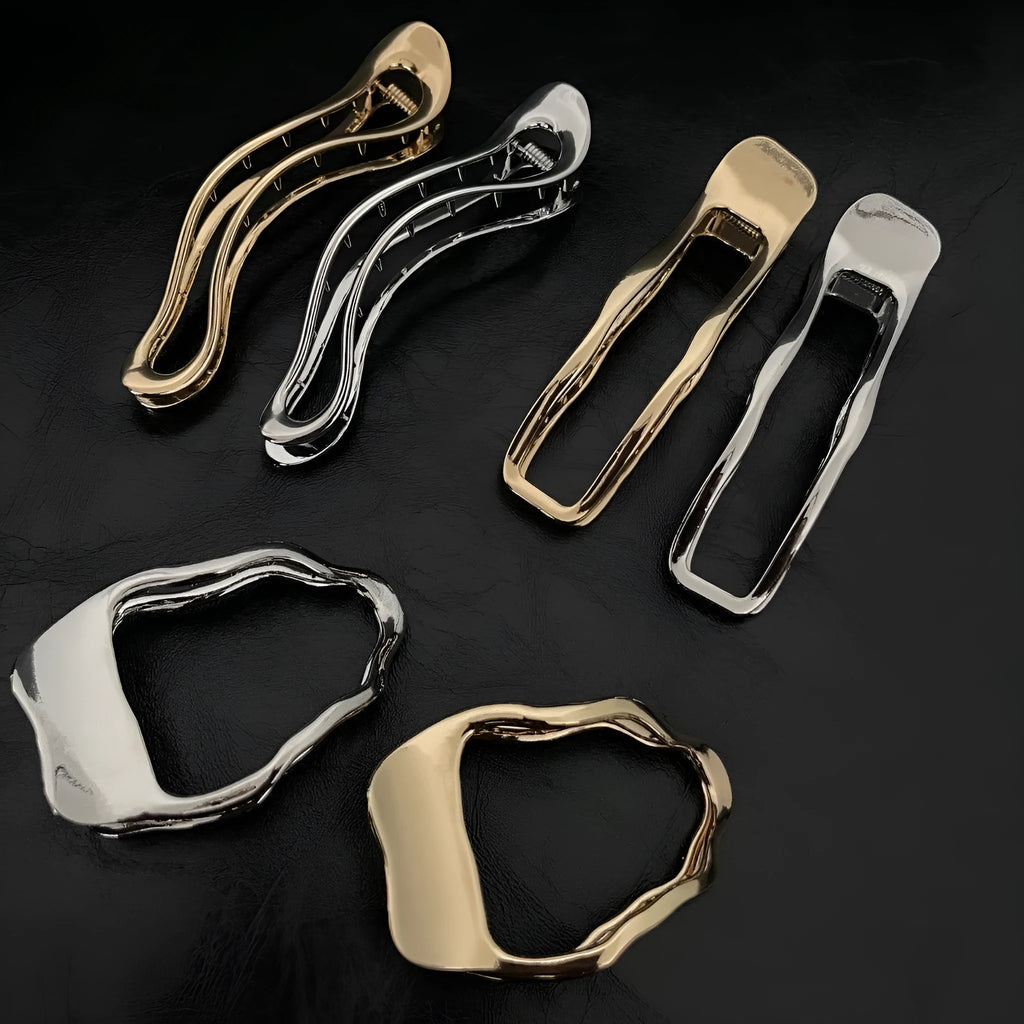 Gold and silver zinc alloy hair barrettes showing arc, square, and triangle shapes on a plain background.