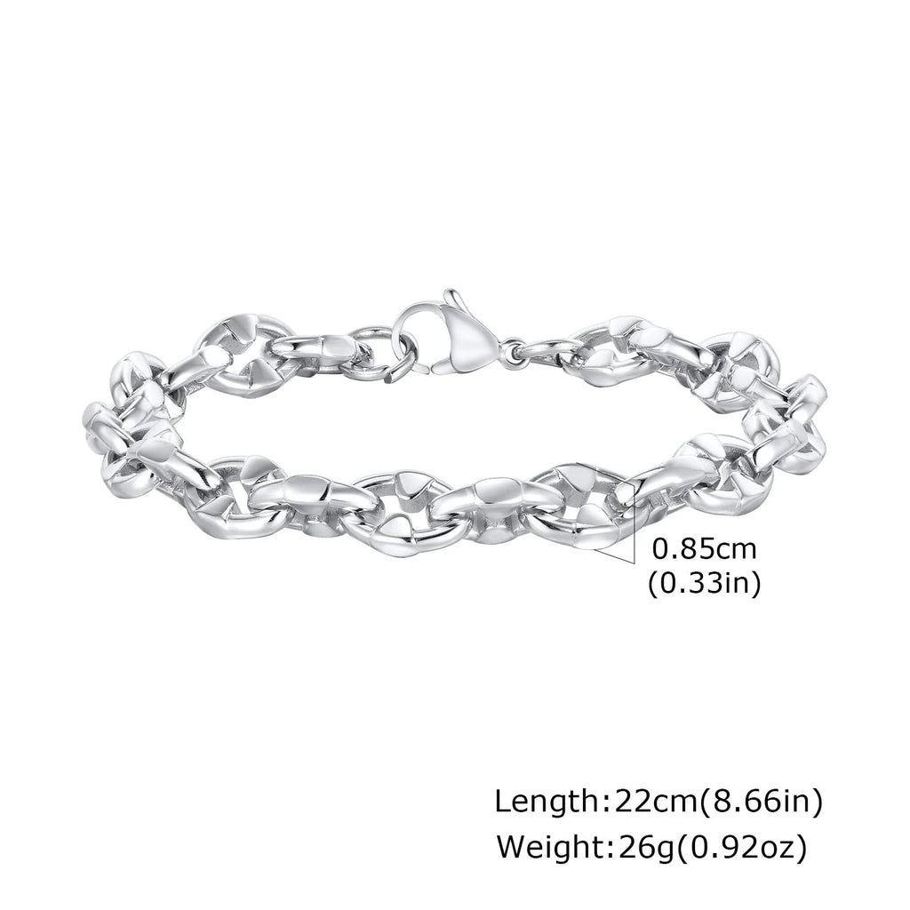 Close-up of a thick geometric chain bracelet made from polished stainless steel, on a wrist.
