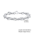 Close-up of a thick geometric chain bracelet made from polished stainless steel, on a wrist.