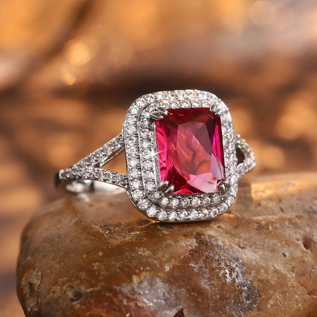 Geometric square red copper ring with a central rhinestone, shown from above.