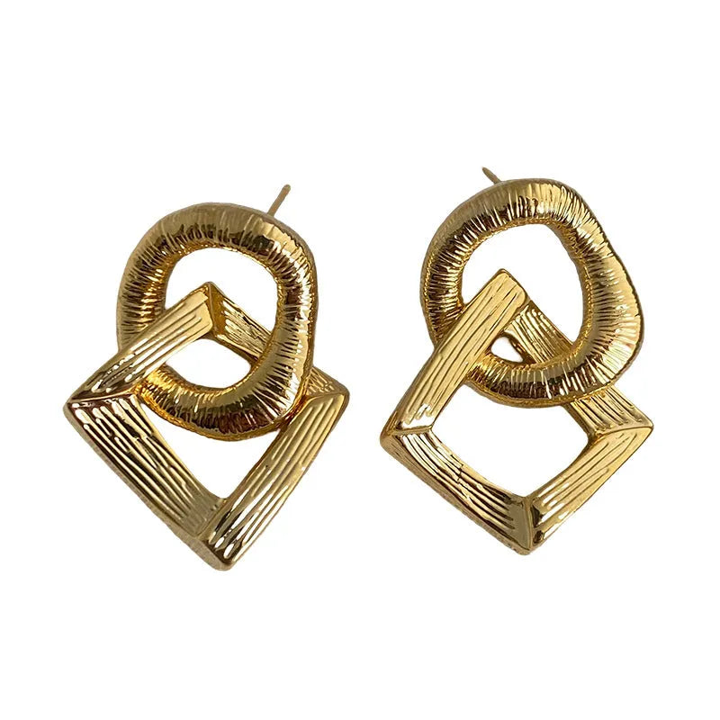Geometric circle pendant earrings in gold or silver electroplated finish on copper, measuring 3.4cm height