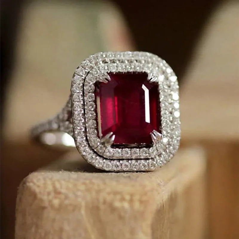 Geometric square red copper ring with a central rhinestone, shown from above.