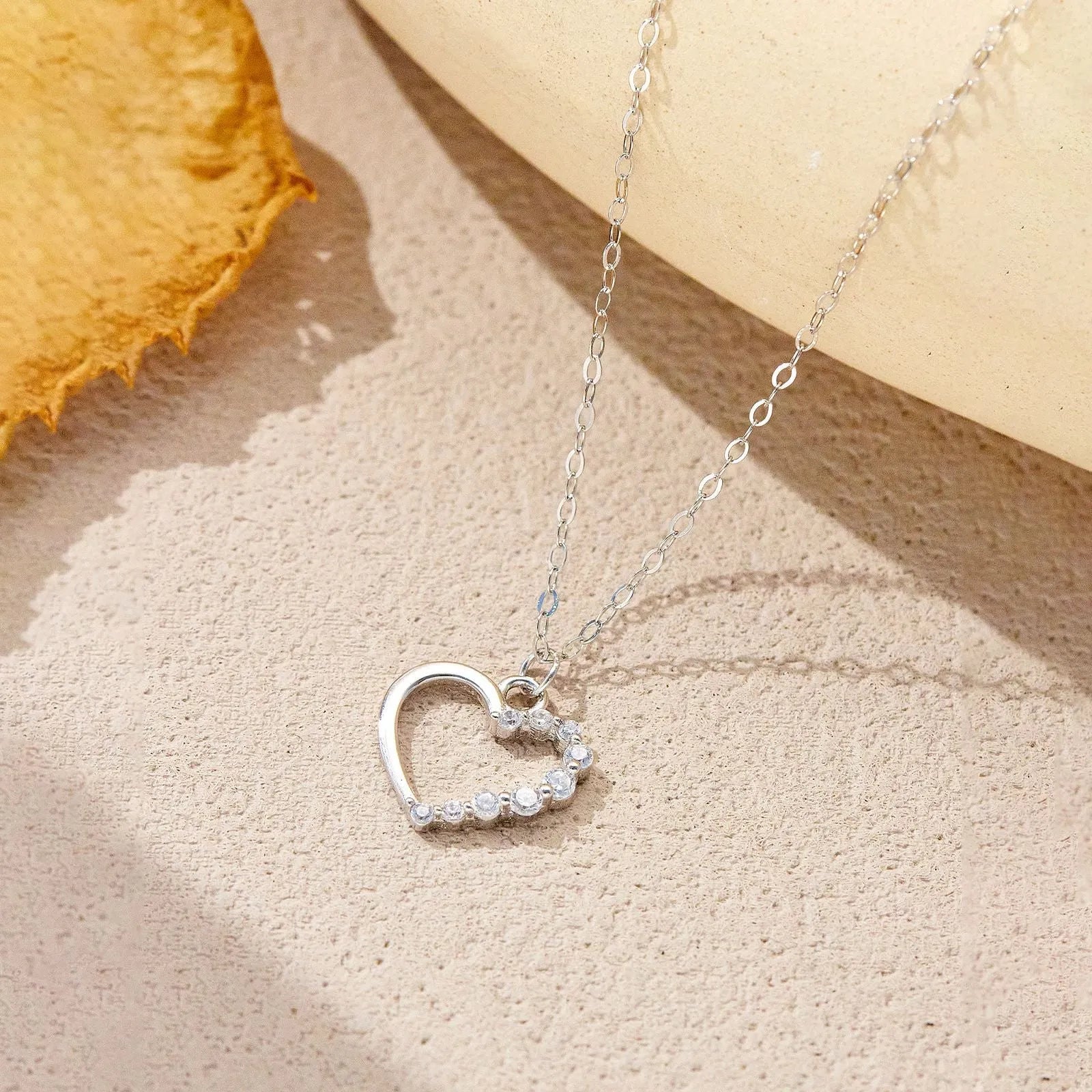 S925 sterling silver hollow heart pendant necklace with regular chain, available in white gold or 18K gold finish.