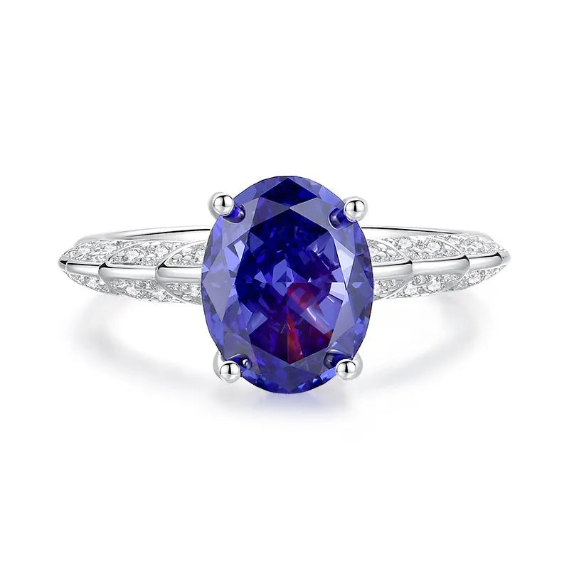 Heart-shaped sterling silver ring with ice flower cut zircon stone in a Tan Sang colour on a finger.