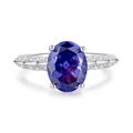 Heart-shaped sterling silver ring with ice flower cut zircon stone in a Tan Sang colour on a finger.