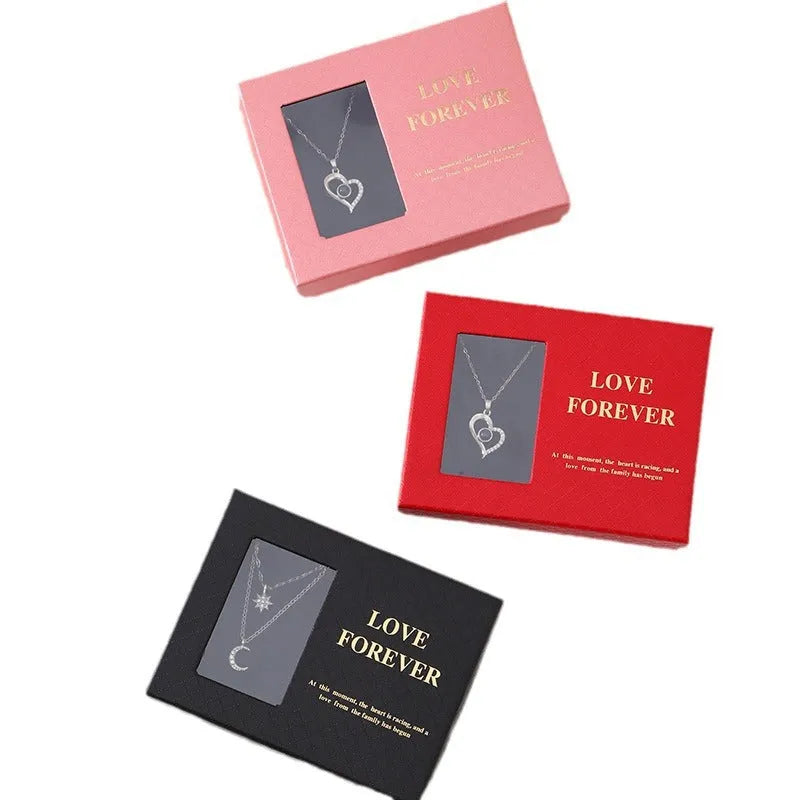Red Valentine's gift box open to show six pink soap roses with a matching handbag beside it