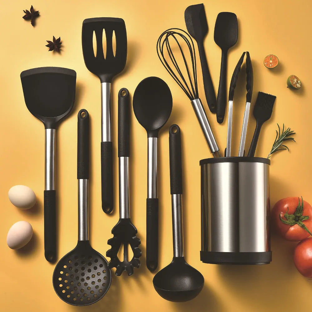 12-piece black silicone kitchen utensil set including spatula, spoon, and claw tools in a rotating storage bucket on a kitchen counter.