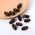 Dark coffee coloured oval wooden beads with M-shaped raised texture, 25mm size