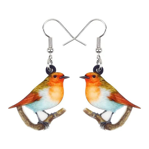 Pair of blue and white acrylic pendant earrings featuring a printed titmouse bird and snake design on geometric shapes.