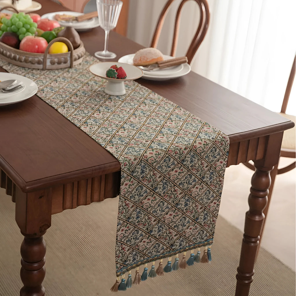 Dark blue Nordic stripe pattern jacquard table runner with tassel detail on a wooden table.