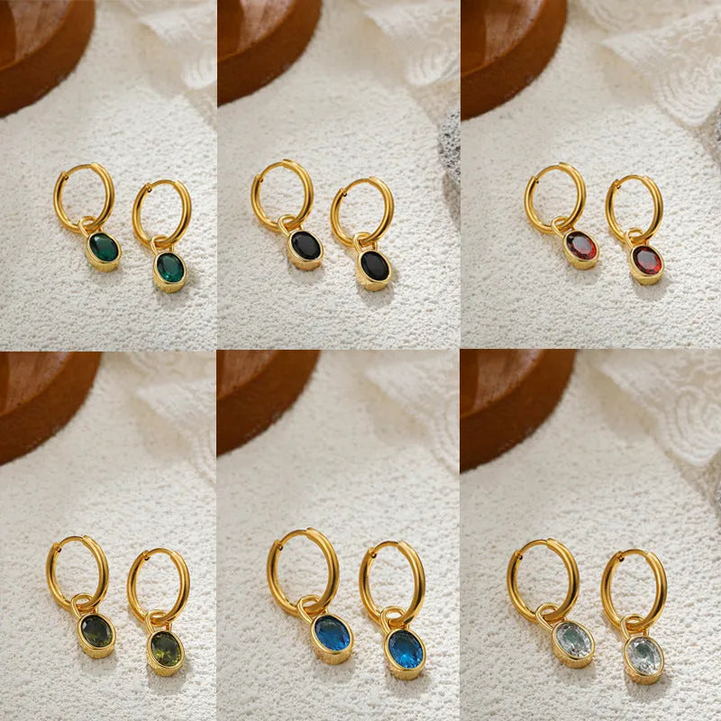 Women's oval zircon clip earrings in army green with polished copper setting on a white background.