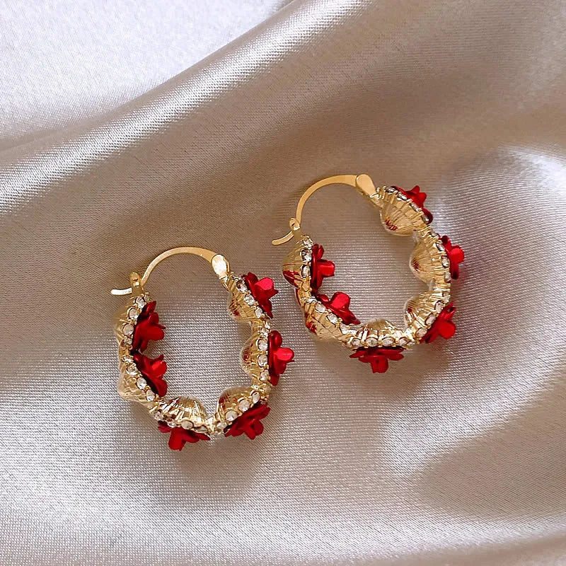 Red flower-shaped alloy ear clip earrings with rose design elements for women