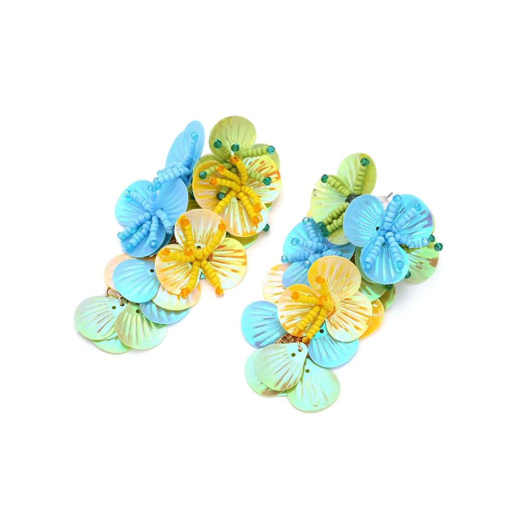 Close-up of handmade exaggerated flower and leaf bead earrings in a colourful colour option.