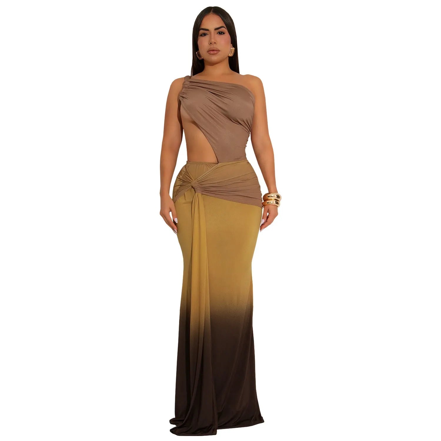 A woman wearing a long, gradient-coloured dress with a cross-shoulder design and high waist.