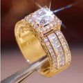 Geometric women's alloy ring with round detail in gold or white electroplated finish on a finger.